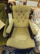 An Edwardian mahogany button back armchair with upholstered seat,