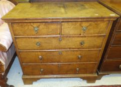 An 18th Century oak and walnut chest with later herringbone and cross-banded top over an ogee
