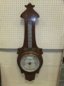 A oak cased aneroid barometer by Douglas Stourbridge bears brass plaque inscribed "Presented to Mr