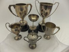 A box containing assorted silver and plated trophy cups