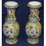 A pair of 19th Century Chinese porcelain baluster shaped vases with applied dragon decoration in the