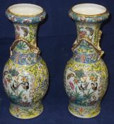 A pair of 19th Century Chinese porcelain baluster shaped vases with applied dragon decoration in the