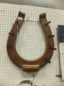 An oak whip rack in the form of a horseshoe with brass nails CONDITION REPORTS