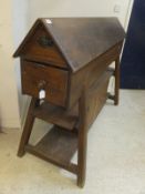 A large pine free-standing saddle horse with drawers and cupboard and shelves beneath,