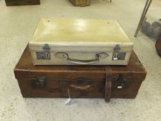 A vintage brown leather suitcase,