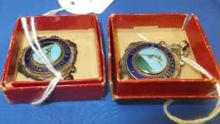 A pair of white metal Stroud and District Schools sports medals