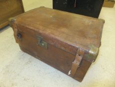 A vintage brown leather metal-bound travelling trunk with fitted interior