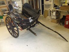 A Governess cart with black painted body and mud guards, with black leatherette upholstered seats,