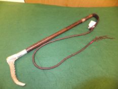 A Swaine & Adeney antler handled riding crop with plaited leather shaft and thong and silver