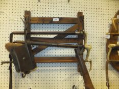 A wooden whip rack in the form of a four bar gate, together with a three various crops / whips,