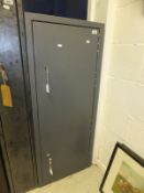 A grey painted metal lockable cabinet (exterior hinge so non-compliant for guns)