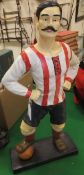 A ceramic model of a footballer in Gloucester colours