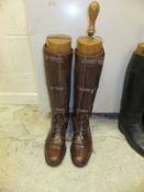 A pair of brown leather field boots with wooden trees CONDITION REPORTS One tree is