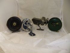 Four assorted fishing reels, to include an Ambidex fixed spool reel,