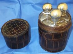 Three glass flasks with electro-plated screw thread lids in a crocodile skin casing