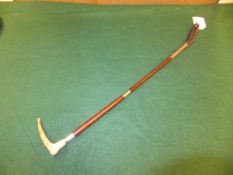 A child's riding crop with antler handle and leather and malacca cane shaft,