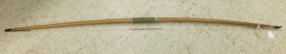 A yew wood longbow with horn ends and mother of pearl decoration