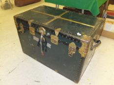 A vintage dark green brass-bound travelling trunk,