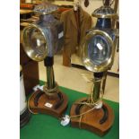 A pair of coaching lamps mounted on horseshoe bases as table lamps