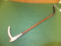 A Swaine & Adeney antler handled riding crop with leather plaited shaft and silver ferrule,