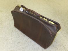 A large leather brass-mounted Gladstone bag with fitted interior