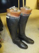 A pair of black riding boots with Maxwell trees