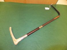 A gentleman's riding crop with antler handle and leather and plaited string shaft,