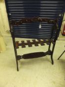 An early 20th Century mahogany free-standing boot and whip rack with Gothic style decoration