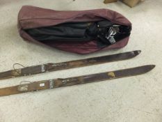 A burgundy Ben Sayers bag containing a quantity of golf clubs,