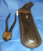 A pair of wire cutters in a brown leather saddle case for huntsmen