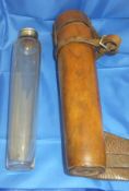 A tapered glass flask with electro-plated screw lid in a brown leather holder CONDITION