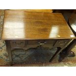 An oak three drawer lowboy with shaped apron,