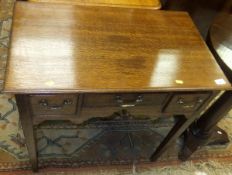 An oak three drawer lowboy with shaped apron,