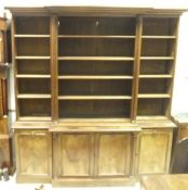 A 19th Century framed mahogany breakfront open bookcase with moulded cornice above adjustable