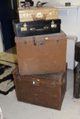 Two canvas covered shipping trunks, a black leather covered travelling case inscribed "Tonnel,