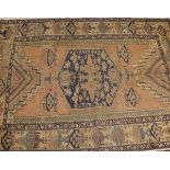 A Caucasian rug, the central medallion in dark blue and salmon,