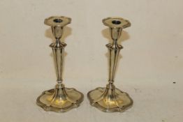 A pair of silver candlesticks raised on shaped oval bases (Sheffield,