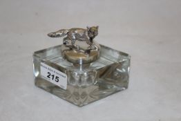 A cut glass lozenge shaped inkwell with electro-plated mounts and fox finial