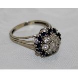 A sapphire and diamond white gold mounted cluster ring, approx 1.