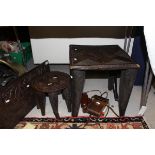 A Nupe carved hardwood stool, the rectangular top on four tapered legs united by stretchers,