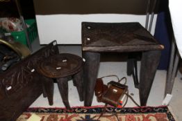 A Nupe carved hardwood stool, the rectangular top on four tapered legs united by stretchers,