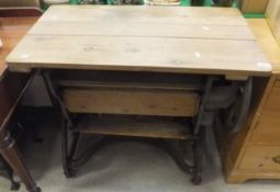 A vintage cast iron framed mangle with pine top