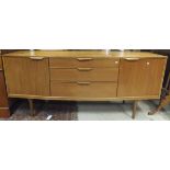 A 1960's Scandinavian teak shallow bow fronted sideboard with three central graduated drawers