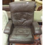 An Ekornes style stressless brown leather armchair and footstool