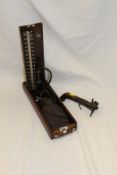 A 19th Century flintlock tinder lighter and a mahogany cased Accoson sphygmomanometer