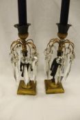 A pair of 19th Century patinated and gilt bronze candle lustres in the French Empire taste,