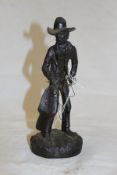 A 20th Century cast bronze figure of a cowboy with a lasso,