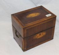 An early 19th Century mahogany and inlaid cased decanter box containing six gilt decorated square