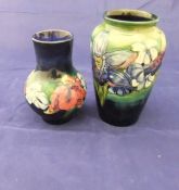 A Moorcroft "Iris" pattern vase and a Moorcroft baluster shaped vase decorated with flowers (2)