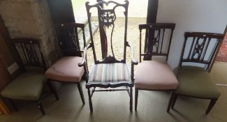 A collection of Edwardian mahogany chairs comprising a carver chair with pierced back splat and two